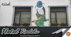 a building with a bird painted on the side of it at Hotel Rodelu in Latacunga