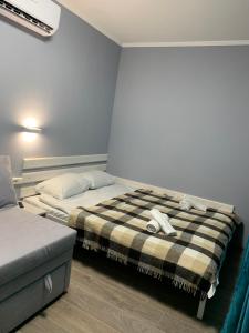 a bedroom with two beds and a couch in it at Lito in Zatoka