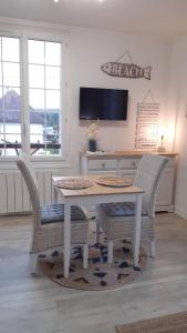 a dining room with a table and two chairs at Studio proche du centre ville et de la plage in Villers-sur-Mer