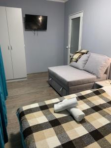 a living room with a bed and a couch at Lito in Zatoka +1 photo