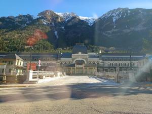 a large building with a mountain in the background at El Canfranero in Canfranc-Estación
