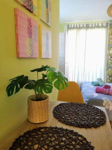 a room with a table with a potted plant on it at Tropical Loft with View in Volos +5 photos