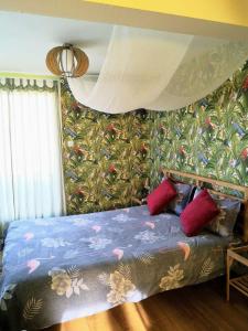 a bedroom with a bed with a floral wallpaper at Tropical Loft with View in Volos