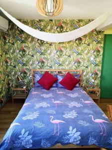a bedroom with a blue bed with pink flamingos on it at Tropical Loft with View in Volos