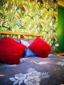 a bedroom with red and blue pillows on a bed at Tropical Loft with View in Volos