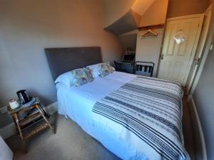 a bedroom with a bed and a desk at The Priory in Hereford