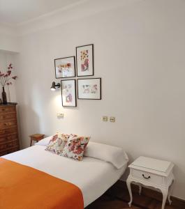 a bedroom with a bed and four pictures on the wall at Spacious Confortable Next Beach and Pintxos Area in Donostia-San Sebastián