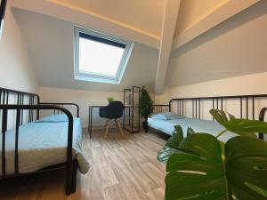 a bedroom with two beds and a window at Capstay - Trith Netflix in Trith-Saint-Léger