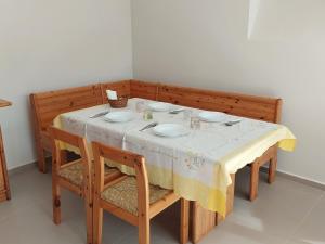 a dining room table with a yellow and white table cloth at B&B VILLA LA GINESTRA in Boscoreale
