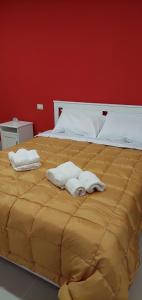 a bedroom with a large bed with towels on it at B&B VILLA LA GINESTRA in Boscoreale