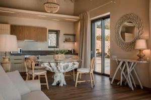 a kitchen and dining room with a table and chairs at Zeus Exclusive Villas in Spartia