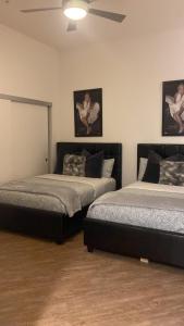 a bedroom with two beds and two pictures on the wall at Exceptional Loft FREE Parking and WIFI in Los Angeles