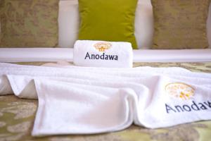 a hotel room with two towels on a bed at Anodawa Boutique Villa in Tangalle