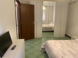 a hotel room with a television and a bedroom at Smeraldo in Levanto