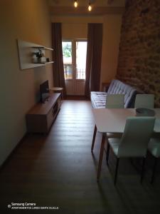 a living room with a couch and a table at Apartamentos Lares in Santa Olalla