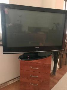 a flat screen tv sitting on a wooden dresser at Apartment Ela Centre in Košice