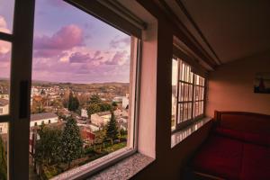 a room with a window with a view of a city at Pension Escalinata in Sarria