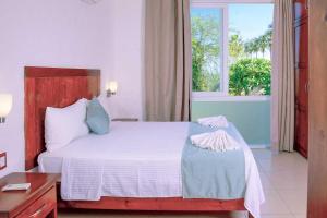 Postel nebo postele na pokoji v ubytování Villas & Resort Luz de Luna