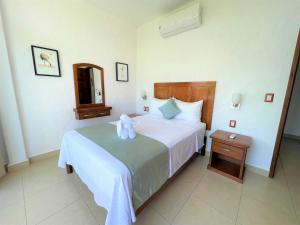 Postel nebo postele na pokoji v ubytování Villas & Resort Luz de Luna