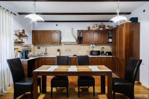 a kitchen with a table and chairs in a room at Floarea Bucovinei in Vama