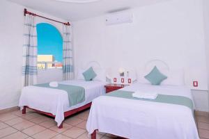 Postel nebo postele na pokoji v ubytování Villas & Resort Luz de Luna