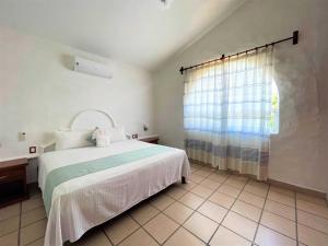 Postel nebo postele na pokoji v ubytování Villas & Resort Luz de Luna