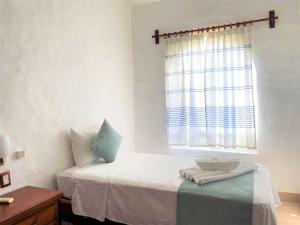 Postel nebo postele na pokoji v ubytování Villas & Resort Luz de Luna