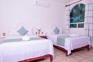 Postel nebo postele na pokoji v ubytování Villas & Resort Luz de Luna