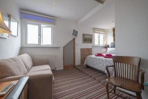 a living room with a couch and a bed at Cornerways Guest House in St Ives +25 photos