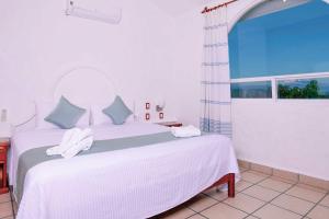 Postel nebo postele na pokoji v ubytování Villas & Resort Luz de Luna