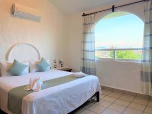 Postel nebo postele na pokoji v ubytování Villas & Resort Luz de Luna