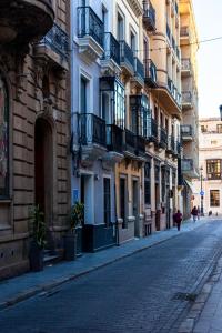 una strada vuota in una città con edifici di Ibarra Hostel a Siviglia