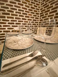 a table with plates and wine glasses on it at TM Apartment No 2 - Scandinavian Style in Aridaia