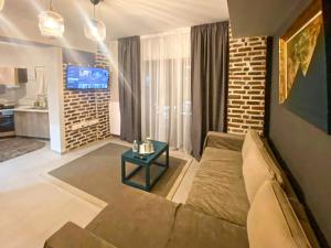 a living room with a couch and a table at TM Apartment No 2 - Scandinavian Style in Aridaia