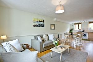 a living room with a couch and a table at East Thorne - Cornwall in Bude