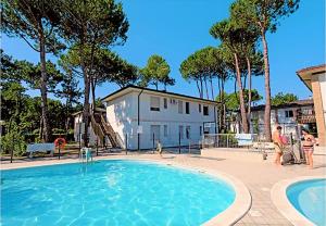 una grande piscina con persone che lo circondano di Green Holiday Village with Pool a Bibione