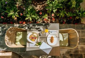 a table with two plates of food on it at Hotel Parco Smeraldo Terme in Ischia