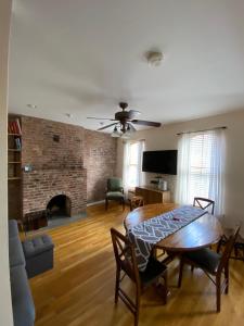 a living room with a table and a fireplace at Riverhouse Extended Stay Apartment in Jersey City