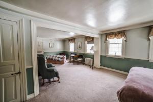 a bedroom with a bed and a living room at Adair Country Inn & Restaurant in Bethlehem