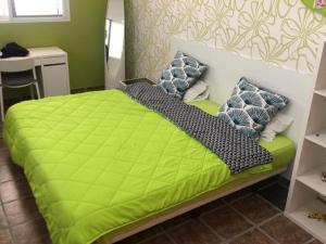 łóżko z zieloną kołdrą w pokoju w obiekcie Maravisa w mieście Puebla de Vallbona