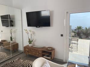 A television and/or entertainment centre at Luxury studio, sea view, pool
