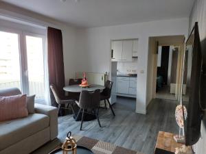 a living room with a couch and a table at Appartement Ter Zee in De Panne