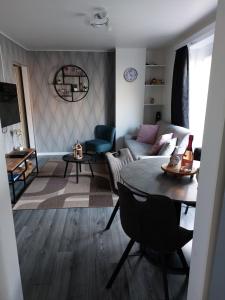 a living room with a couch and a table at Appartement Ter Zee in De Panne