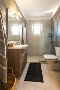 a bathroom with a sink and a toilet and a shower at City Center Elite Suite in Rhodes Town