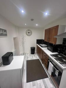 a kitchen with wooden cabinets and a stove top oven at The Honley hotel in Blackpool