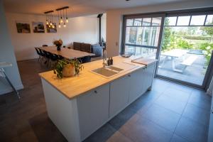 a kitchen with a large island with a counter top at Vakantiewoning De Machuut in Lo-Reninge