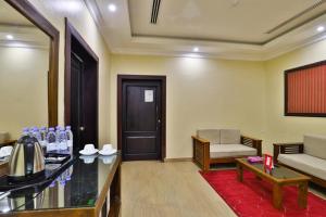 a living room with a couch and a table at فندق بفن Puffin Hotel in Al Nairyah