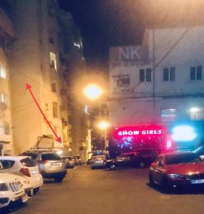 a group of cars parked on a city street at night at BroBro hostel in Tbilisi City