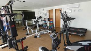 a gym with several exercise equipment in a room at Praia de Guarajuba-Porto Smeralda in Guarajuba +29 photos