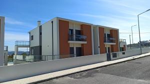 a building with balconies on the side of a street at Vista da Baia in Salir do Porto